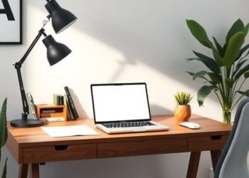 A modern home office desk setup with a laptop, lamp, and plants.