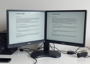 A double monitor setup with minimal visible cables on a clean desk.