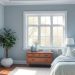A calming master bedroom with soft blue walls, wooden furniture, and natural light.