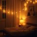 A warm bedroom with soft lighting, featuring a bed, lamp, and string lights.