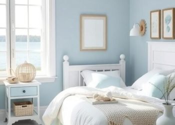 A coastal-themed bedroom with blue walls, white furniture, and nautical decor.