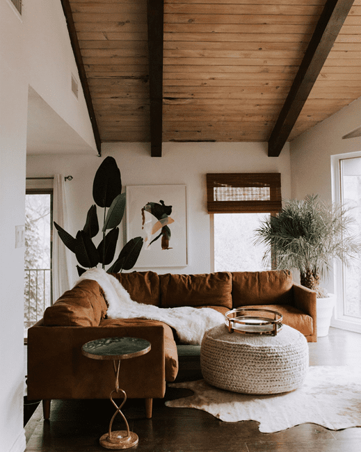 earthy living room with brown sectional and light color palette