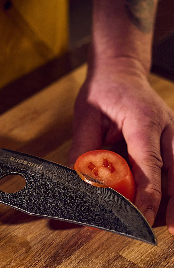 Man cutting tomato with Matsato Osuren Knife
