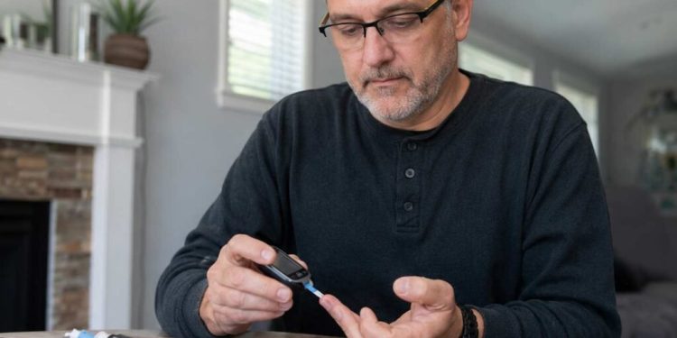 Man checking his blood sugar with a blood sugar monitor
