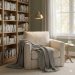 A cozy reading nook with a plush armchair a soft blanket and a bookshelf