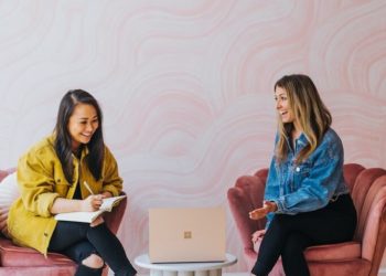 3 women sitting on chair