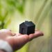 A person holding a small house in their hand