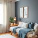 A cozy home office featuring a daybed, dark gray wall, light curtains, and blue accents.