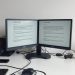 A double monitor setup with minimal visible cables on a clean desk.