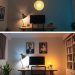 A comparison of two home office lighting setups showing warm yellow light above and cool blue light below.