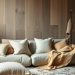 A cozy living room with a light-colored sofa, various textured pillows, and a decorative rug on a wooden floor.