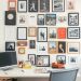 A home office with a gallery wall featuring various framed photos and art pieces.