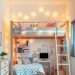 A stylish girl's bedroom featuring a trendy loft bed with a desk underneath, warm lighting, and colorful decor.