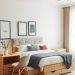 A modern bedroom featuring a bed with storage drawers, bedside tables, and a chair, all in light colors and natural wood.