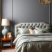 A stylish grey bedroom featuring a tufted headboard, gold accents, and elegant decor.