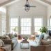 Cozy farmhouse living room with soft sofas, a coffee table, and large windows