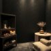 A serene spa setting featuring textured black wallpaper, soft lighting, candles, and a cozy arrangement.