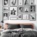A stylish bedroom featuring a bed with dark bedding and a wall adorned with black and white photography in various frames.