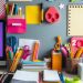 A colorful array of office accessories including pens, sticky notes, and notebooks on a desk.