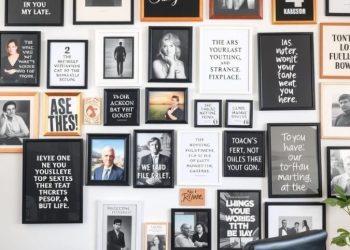 A gallery wall with various framed quotes and photos in a home office setting.