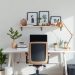A stylish and functional home office desk arrangement with a white desk, comfortable chair, and decorative elements.