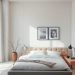A modern minimalist bedroom featuring a neatly made bed, soft lighting, and simple decor.