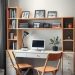 A cozy and organized home office featuring a desk with shelves, a computer, and folding chairs.