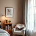 Cozy bedroom reading nook with a chair, open book, and soft lighting.