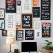 A home office wall decorated with motivational quotes and affirmations in various frames.