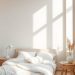 A minimal bedroom with neutral colors, featuring a bed with white bedding, wooden furniture, and soft natural light.