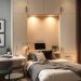 A modern home office with a Murphy bed design, featuring a desk, chair, and cozy bedding.