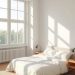 A bright, minimalist bedroom with a bed, bedside tables, and large windows.
