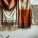 A stylish display of textured fabric wall hangings in warm colors.