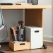 A tidy under-desk storage setup featuring wooden drawers and a white box for organization.
