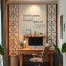A stylish home office setup with a room divider, desk, and decorative plants.